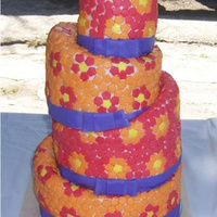 Hippie Topsy-Turvy Wedding Cake Cake was made for ex-hippies. She wanted a topsy-turvy with bright colors and lots of flowers so she got it and loved it! There are over...