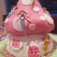 Fairy Toadstool Cake Made this for my daughter's 3rd birthday from Debbie Brown's 50 (not so) easy birthday cakes. Its my first sculpted cake.