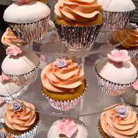 First Attempt At Cupcakes A tower of cupcakes, mixing buttercream swirls with royal icing roses with fondant topped cupcakes and fondant country daisies