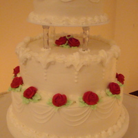 Traditional Wedding Cake Traditional style wedding cake with butter cream decorations. Green butter cream icing for leaves and red royal icing for roses.