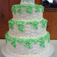 Basket Weave Wedding Cake Three tiered wedding cake with butter cream icing in basket weave design. Two shades of green butter cream to form ivy.