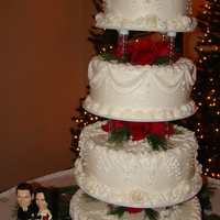 Buttercream Wedding Cake This was for a Christmas silver and red wedding. White and Chocolate cake on four tiered cake stand accented with red Charlotte roses and...