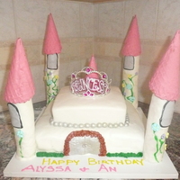 Princess Cake Two tier vanilla and strawberry swirl covered in MMF. Pillar's are rice krispees wrapped in fondant with waffle cones dipped in...