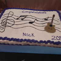 My Son's Graduation Cake two 9x13 cakes- half chocolate, half yellow with buttercream icing and fondant guitar(can't take credit for the guitar,my son's...
