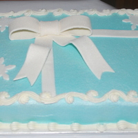 Christmas Package Birthday Cake This is half white and half chocolate with buttercream and fondant bow and snowflakes. I also sprayed edible shimmer spray all over.