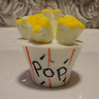 Popcorn Cake Pop Oh my goodness. This is a yummy rich buttery cake pop dipped in almond chocolate and topped with mini marshmellow.