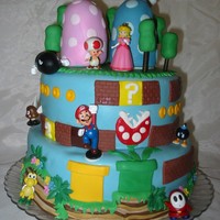 Mario Bros everything is fondant, except characters were purchased..."mushroom" hills are crispy treats covered with fondant...trees are...