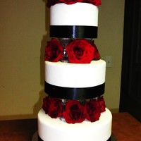 Eelegant Wedding Cake With Red Roses Made with fondant, ribbon, and fresh flowers