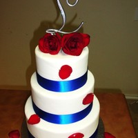 Wedding Cake With Blue Ribbon And Red Roses I love this cake. It's made with fondant, ribbon and fresh roses.