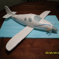 Lancair Evo Groom's cake for a guy that builds these planes. WASC with banana buttercream filling. Wings are RKT on wires, covered in fondant. TFL...