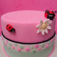 Lady Bugs When i was done with this cake it made me smile :) Its a 6 inch covered with mmf, ladybugs nd daisy are fondant as well. Thanx for looking...