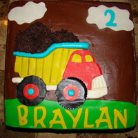 Dump Truck Cake 2 layer 12 inch chocolate cake covered in chocolate buttercream. Fondant accents cut using cricut cake machine. "Dirt" was made...