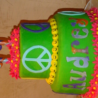 Peace And Love Birthday Cake Chocolate with chocolate filling, covered in lime green MMF, and MMF accents. Peace signs and name cut with ciricut cake. Flowers dusted...