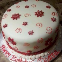 Red And White Themed Birthday Cake Chocolate cake with chocolate/peanut butter filling. Covered in white MMF, with red fondant flowers and buttercream piped swirls