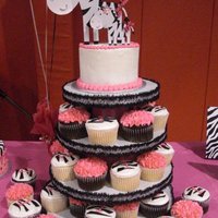 Zebra Cupcakes homemade cupcake stand with cake dummy on top with cardboard zebras. cupcakes are vanilla and chocolate with hot pink buttercream on top...