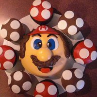 Mario Brothers Cake Mario is a 6" cake with fondant details. cupcakes are buttercream with fondant details.