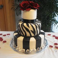 Black, Red And White Wedding Cake This was my first wedding cake! The bride had to book me last minute and I basically went off what she told me over the phone. When I...