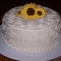 Sunflowers I loved making this cake! 8inch round covered in buttercream. Hand piped swirls and fondant sunflowers on top!