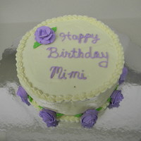Mother's Birthday Cake Banana cake with cream cheese frosting and purple royal icing roses.