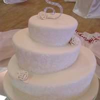 Whimsical Wedding 8", 12" and 16" topsy turvy cake covered in homemade MMF and royal icing stenciling on side.