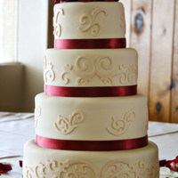 Ivory And Burgundy Wedding Cake Round wedding cake w/ ivory fondant, flourishes cut with Cricut Cake, topped with gumpaste roses.