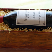 Wine Bottle Birthday Cake carved wine bottle cake covered with fondant inside a "crate" made of cake, covered w/ fondant. Straw is made of gumpaste.