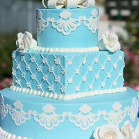 Blue And White Wedding Cake (Vow Renewal) Blue buttercream w/ gumpaste designs, gumpaste roses and small blossoms.