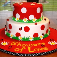 Ladybug Baby Shower Cake Two-tiered fondant cake w/ gumpate daisies and lady bugs.