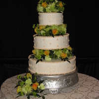 My First Dummy. 3 tiered white dummie with ivory details. Assorted fresh flowers on top and in between tiers.