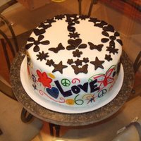 Groovy Peace Sign Cake Hand painted on faux fondant with fondant cutouts in the shape of a peace sign.