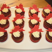 Canada Day Cupcakes! Almond cupcakes with chocolate ganache and vanilla buttercream. Maple leaves are fondant.