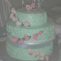 Wedding.jpg Made this for a friend's wedding. First time working with gumpaste and tiers. Turned out ok for never being trained i guess.