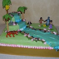 Jungle Book Cake 1/2 sheet base, various rounds and oval cakes stacked and carved to create "mountain" covered cake in green buttercream, marbled...