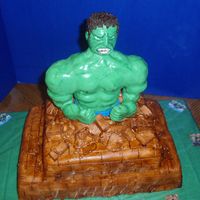 Hulk The Incredible Two tiered vanilla cake covered with fondant. The figure is made out of rice crispy treats covered with gumpaste. Airbrush technique to...
