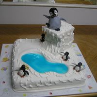 Happy Feet I made this cake with with fondant and Gum Paste. I modeled all the penguins in Gum Paste with royal icing as the melting ice around the...