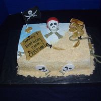 Pirate Cake Bettercream Icing with Gumpaste Decorations. Skull was made out of rice krispy treats covered with gumpaste. Blue Color spray for water...