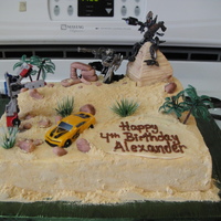 Transformers Birthday Buttercream cake with fondant decorations. The dad provided the Transformer toys