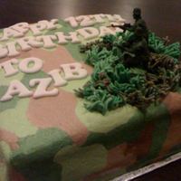 Going To War Carrot cake covered with camouflage-finished buttercream frosting. The grass was made from fondant pressed through a garlic presser.