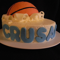 Basketball Cake Chocolate cake, oreo cream filling, buttercream icing with fondant accents. Ball is rice krispies covered in fondant.
