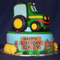 Johnny The Tractor Johnny the John Deere Tractor character. Johnny is confetti cake w/ BC and fondant, tires and support block are RKT. Base cake is Chocolate...
