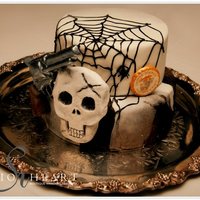 Kyle's Groom's Cake Fondant covered with gumpaste gun and hand sculpted skull. Groom drew picture of what he wanted on his cake. Added the USMC medallion as a...