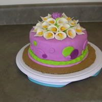 Calla Lily, Polka Dot Cake This is a cake covered in fondant with fondant polka dots and border. The Calla lilies and mum are all gum paste.