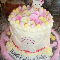 Hello Kitty! Lemon chiffon Hello Kitty Cake. Everything is hand made fondant, except for the jewels on Hello Kitty and the white front and center flower...