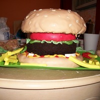 Hamburger The bun is vanilla cake covered in marshmallow fondant and rice-crispy cereal "seeds". The burger itself is a "naked",...