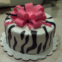 Zebra Stripe My first zebra stripe done for a friend's bday. Strawberry cake with buttercream. Fondant accents. Bow fondant and gum paste