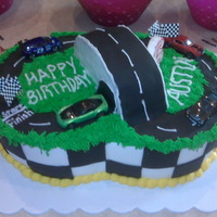 Race Track Cake My son's 6th bday cake. He picked it out off CC. Half strawberry half vanilla with buttercream icing and fondant accents.