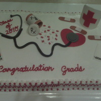 Nurses Graduation Cake Graduation cake for a friend's mom. Got idea from CC. half vanilla half strawberry butterbream icing fondant accents