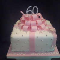 Birthday Gift Vanilla sponge cake filled with strawberries and cream, covered in fondant and modelling paste bow all completely edible with exception of...