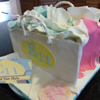 Store Opening This was for an upscale clothing store opening. I matched the logo and the colors of the store/ad. All gumpaste and fondant.