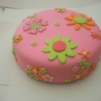Flower Power Birthday Cake Chocolate fudge cake covered with fondant, and fondant flowers. I love the contrast between the bright pink fondant, and the dark brown of...